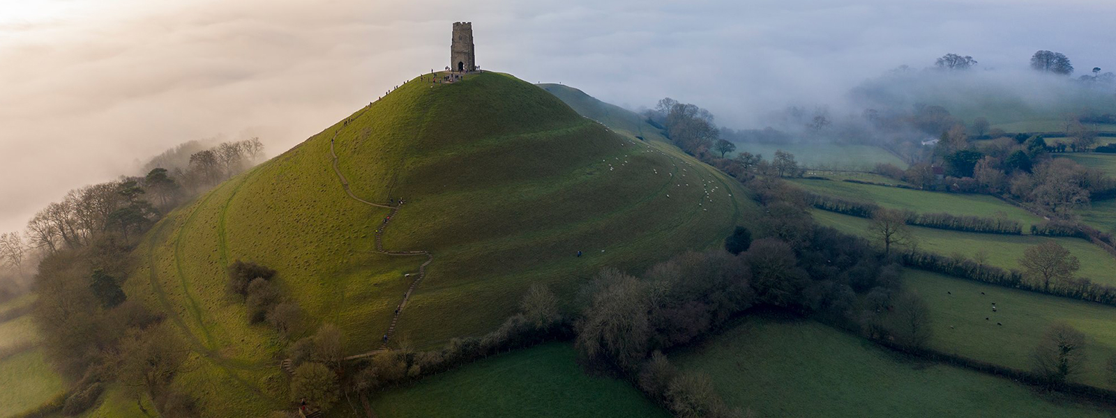 banner for locations of arthurian legend, featuring glastonbury tor